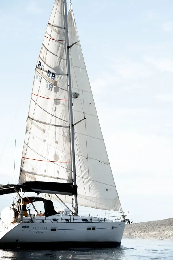 Una barca a vela bianca sul mare calmo